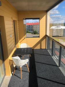 a balcony with a table and two chairs on it at Lumiapartment1 in Rovaniemi