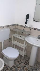 a bathroom with a toilet and a sink at Home Giove in Giardini Naxos