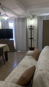 a room with two beds and a cross on the wall at Home Giove in Giardini Naxos