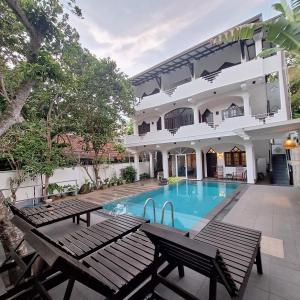 an image of a house with a swimming pool at Villa Goodwill Paradise in Hikkaduwa