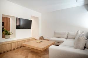 a living room with a couch and a coffee table at Plaka House - Boutique Apartments in Athens