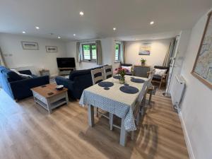 a living room with a table and a couch at The Stables at Hustyn Gate in Wadebridge