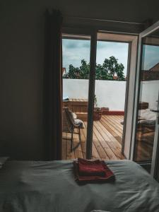 a bedroom with a bed and a view of a deck at La bodeguita terrasse in Saint-Génis
