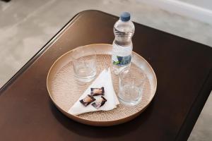 a plate with a bottle of water and two glasses at Casa Salzburg in Sibiu