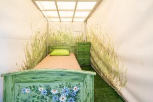 a bed in the corner of a room at Garden Clamping in Tallinn
