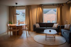a living room with a couch and a table at Penthouse, heart of city center, high standard in Stavanger