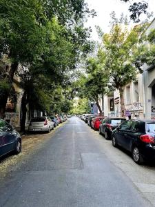 a street with cars parked on the side of the road at Villa Anastasia in Athens