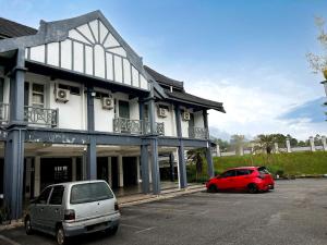 two cars parked in a parking lot in front of a building at Sarina Hotel, Jeli in Jeli +5 photos