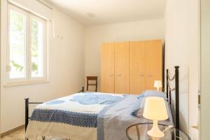 a bedroom with a bed with a table and a window at Residence Anna - Red Apartment in Roseto degli Abruzzi