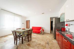 a kitchen and dining room with a table and chairs at Residence Anna - Red Apartment in Roseto degli Abruzzi
