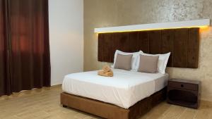 a bedroom with a large bed with a wooden headboard at camping atlantique tan tan in Tan-Tan Plage