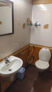 a bathroom with a sink and a toilet and a mirror at Presidency Towers,Kochi in Cochin +41 photos