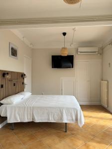 a bedroom with a bed and a flat screen tv at Hostal Restaurant Casa Comaulis in La Vajol +46 photos