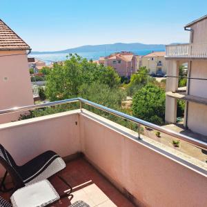 a balcony with chairs and a view of the ocean at Apartments Pletikosa in Brodarica