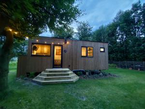 a tiny house with stairs in a yard at Zen huisje in Turnhout