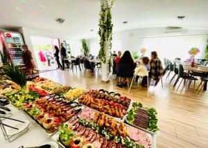 a buffet of food on a table in a room at Vila Salzburg in Ocna Sibiului
