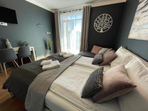 a bedroom with a large bed with pillows on it at Vila Salzburg in Ocna Sibiului