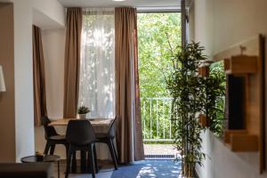 a dining room with a table and a large window at MAKS 3 Osijek Center, self check in, free parking in Osijek