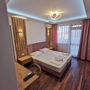 a bedroom with a bed and a remote control at Villa Diana Self check-in in Kiten