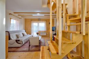 a living room with a couch and a staircase at Family 4M in Zlatibor