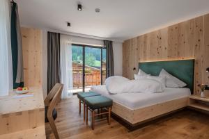 a bedroom with a large bed and a window at Chalet Rudla in Sesto