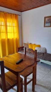 a living room with a wooden table and a couch at Hospedaje Navarro Dpto N3 matrimonial in Navarro