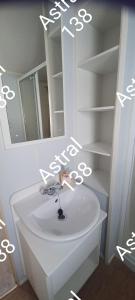 a bathroom with a white sink and a mirror at Astral 138 snowdon summit 098 in Barmouth +6 photos
