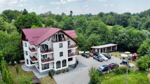 an aerial view of a hotel with cars parked in a parking lot at Oana Boutique CDI in Bran