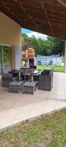 a patio with benches and a table and chairs at Grande maison de 152 m² /6 pers. in Salles