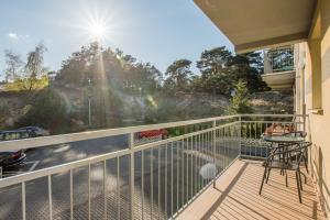 a balcony with a table and chairs and a view at Ustka Apartament Na Wydmie 4 in Ustka