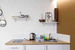 a kitchen with a sink and a counter top at Apartman LIKE Sarajevo 2 in Sarajevo