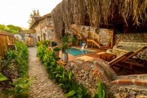 a backyard with a swimming pool and a house at LEVISSI LODGE OTANTIC STONE VILLA in KAYAKOY in Kayakoy