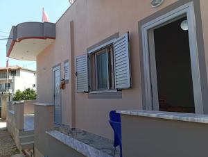 a building with a counter and windows on it at Vila Oriku in Sarandë