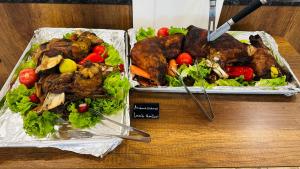 two dishes of meat and vegetables on a table at Queen Nelly Park in Kiten +117 photos