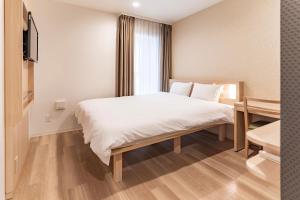 Postel nebo postele na pokoji v ubytování Kansai International Airport Hotel 11