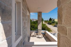 a balcony with a table and chairs on a building at Casa Coral in Crno