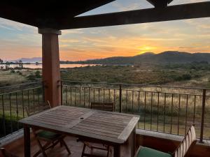 a table on a balcony with a view of the sunset at Casina Maria in Murta Maria