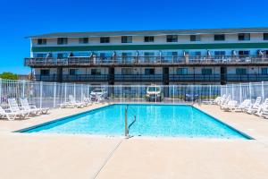 a swimming pool in front of a building at 127th Street OCMD Condo in Ocean City