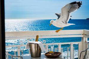 a seagull flying over a table on a cruise ship at Grand Hotel Des Sablettes Plage, Curio Collection By Hilton in La Seyne-sur-Mer