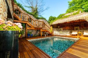 a house with a swimming pool and a patio at LEVISSI LODGE OTANTIC STONE VILLA in KAYAKOY in Kayakoy