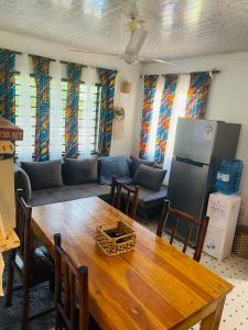 un soggiorno con un tavolo e un divano di Savita House Diani a Magutu