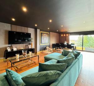 a living room with a blue couch and a table at Samana Vayu in Poole