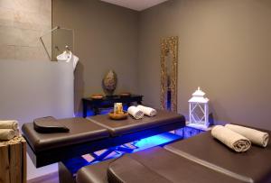 a massage room with a bench and a mirror at Grand Hotel Des Sablettes Plage, Curio Collection By Hilton in La Seyne-sur-Mer