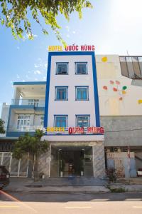 a hotel with a sign on top of a building at Quốc Hùng Hotel in Tam Ky