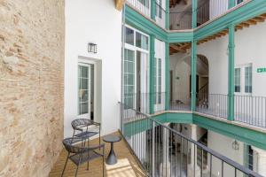 a view of the balcony of a building with two chairs at Palacio Vegafuente by Caleta Homes in Málaga