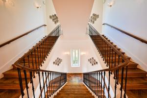 a staircase in a house with wooden floors at Grand Hotel Des Sablettes Plage, Curio Collection By Hilton in La Seyne-sur-Mer