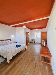 a bedroom with a bed and a wooden floor at ACSIS Mi in Ambaro