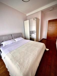 a bedroom with a large white bed in it at Altezza Luxury Apartment 11 in Budva