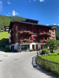 a building with flowers on the balconies on a street at Chalet Annelis Apartments in Zermatt