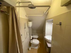 a small bathroom with two toilets and a shower at Sh Suite Borgo in Bracciano